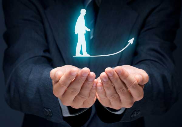 Hands lifting a figure along a rising growth arrow